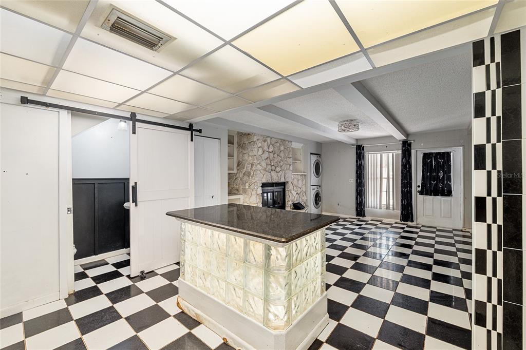 9951 Southwest 88th Court Road, Unit C Ocala, FL 34481 - Photo 11 of 46 a kitchen with a checkered floor and white cabinets