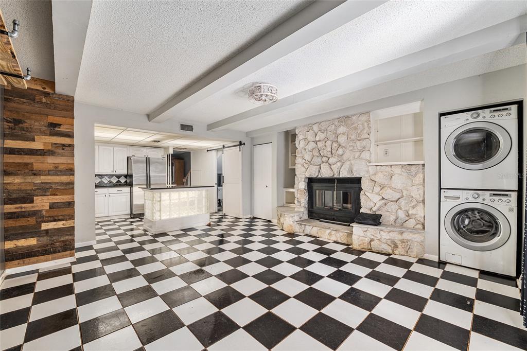 9951 Southwest 88th Court Road, Unit C Ocala, FL 34481 - Photo 15 of 46 a view of a storage and utility room with a washing machine checkered tile floor