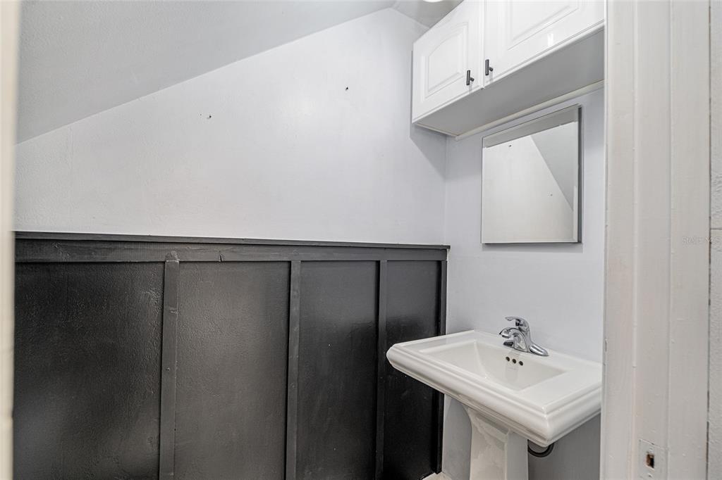 9951 Southwest 88th Court Road, Unit C Ocala, FL 34481 - Photo 19 of 46 a bathroom with a sink a mirror and a toilet