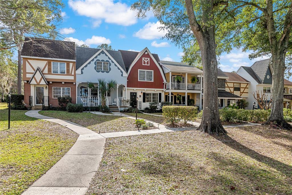 9951 Southwest 88th Court Road, Unit C Ocala, FL 34481 - Photo 2 of 46 a front view of a house with a yard