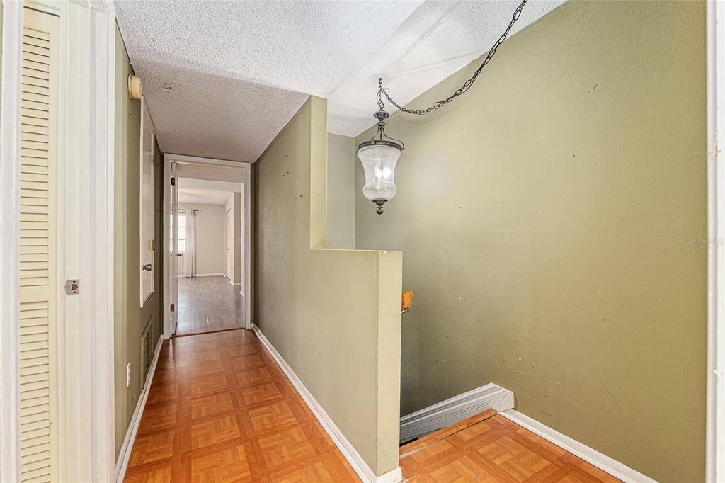 9951 Southwest 88th Court Road, Unit C Ocala, FL 34481 - Photo 21 of 46 a view of a hallway with wooden floor