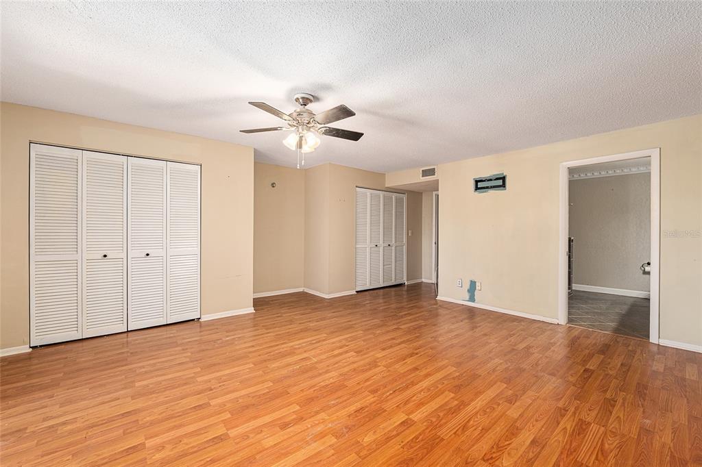 9951 Southwest 88th Court Road, Unit C Ocala, FL 34481 - Photo 25 of 46 a view of an empty room with wooden floor