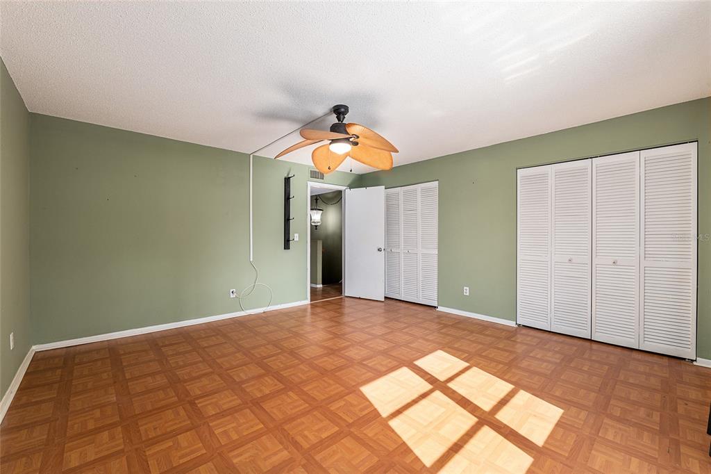 9951 Southwest 88th Court Road, Unit C Ocala, FL 34481 - Photo 32 of 46 a bedroom with a bed and a chandelier