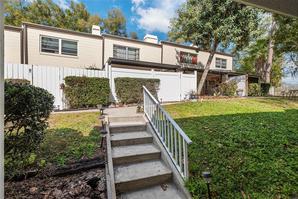 9951 Southwest 88th Court Road, Unit C Ocala, FL 34481 - Photo 42 of 46 a view of a house with backyard and a tree