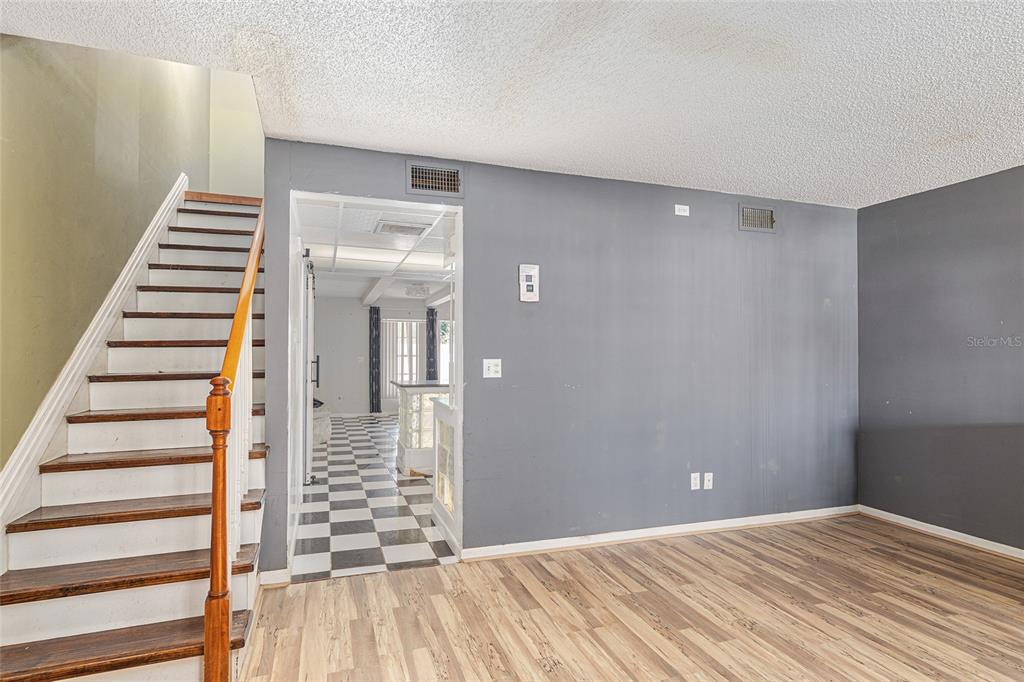 9951 Southwest 88th Court Road, Unit C Ocala, FL 34481 - Photo 7 of 46 a view of a hallway with wooden floor and entryway