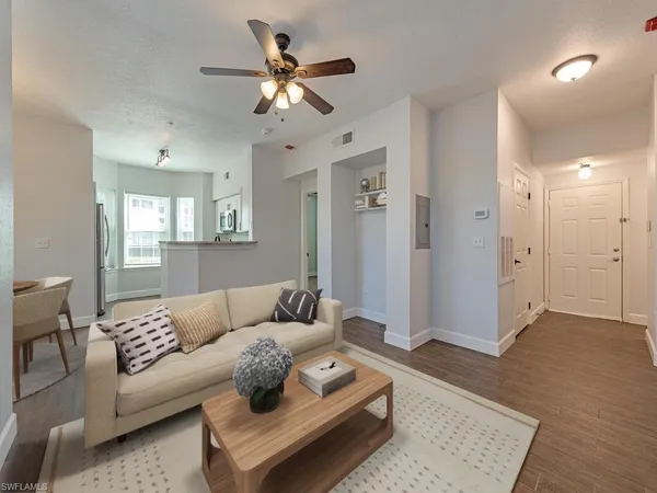 a living room with furniture and a wooden floor