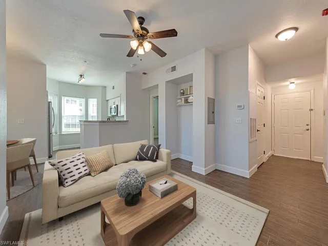 a living room with furniture and a wooden floor