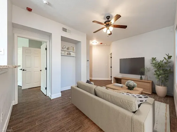 a living room with furniture and a flat screen tv