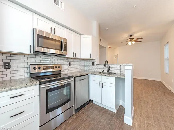 a kitchen with a stove microwave and sink