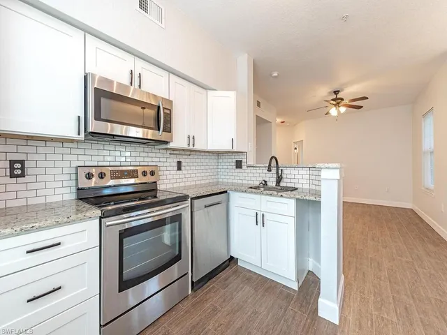 a kitchen with a stove microwave and sink