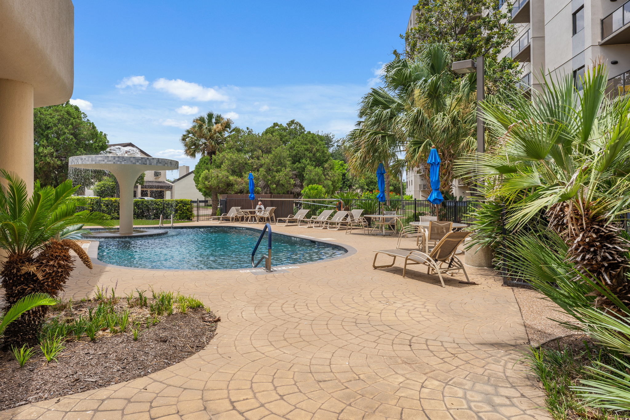 40 North Interstate Highway 35, Unit 11B2 Austin, TX 78701 - Photo 28 of 28 An inviting outdoor pool with a decorative fountain and ample lounge seating for relaxation.