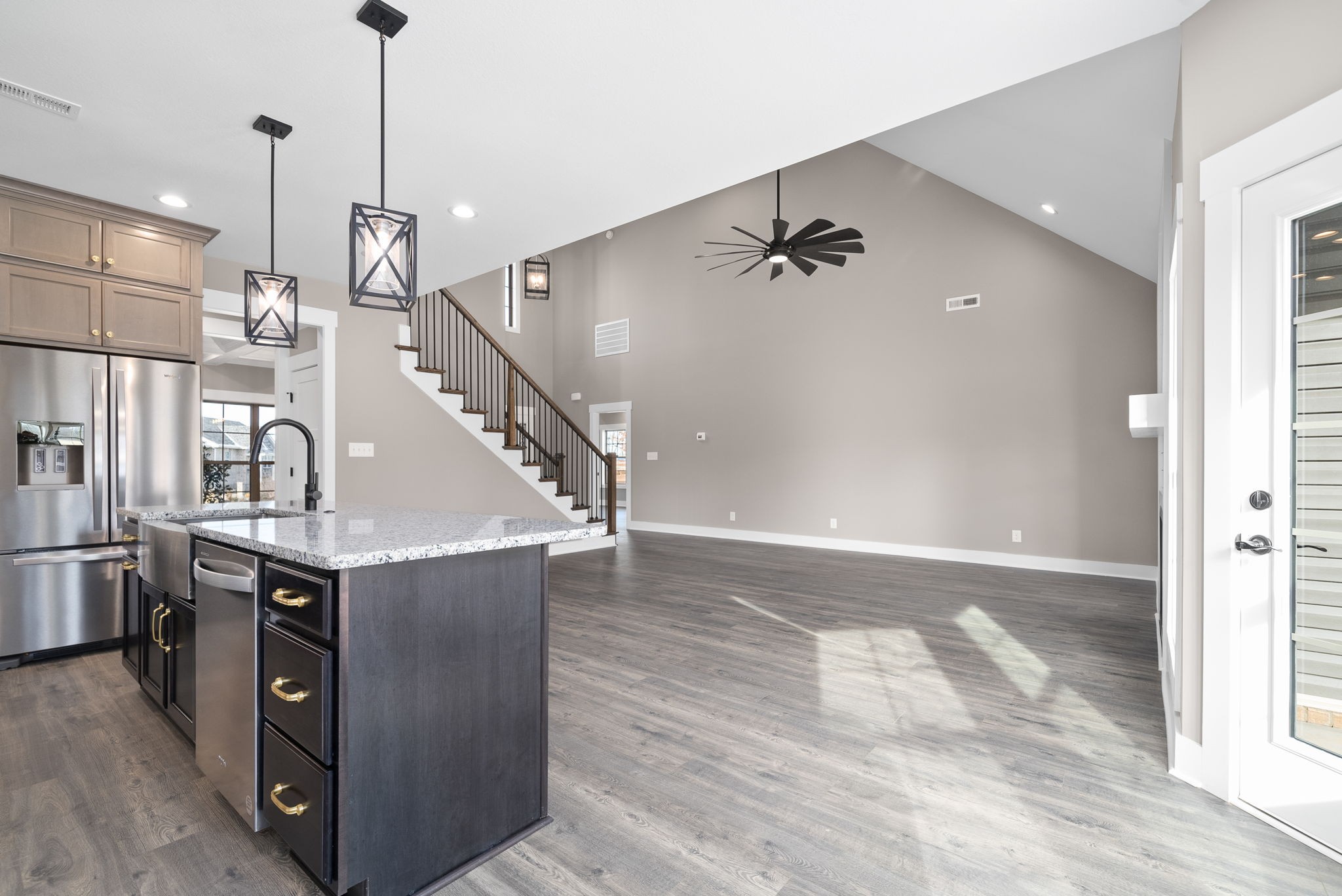 1059 Gratton Road Clarksville, TN 37043 - Photo 11 of 45 a view of a kitchen with kitchen island wooden floor and staircase