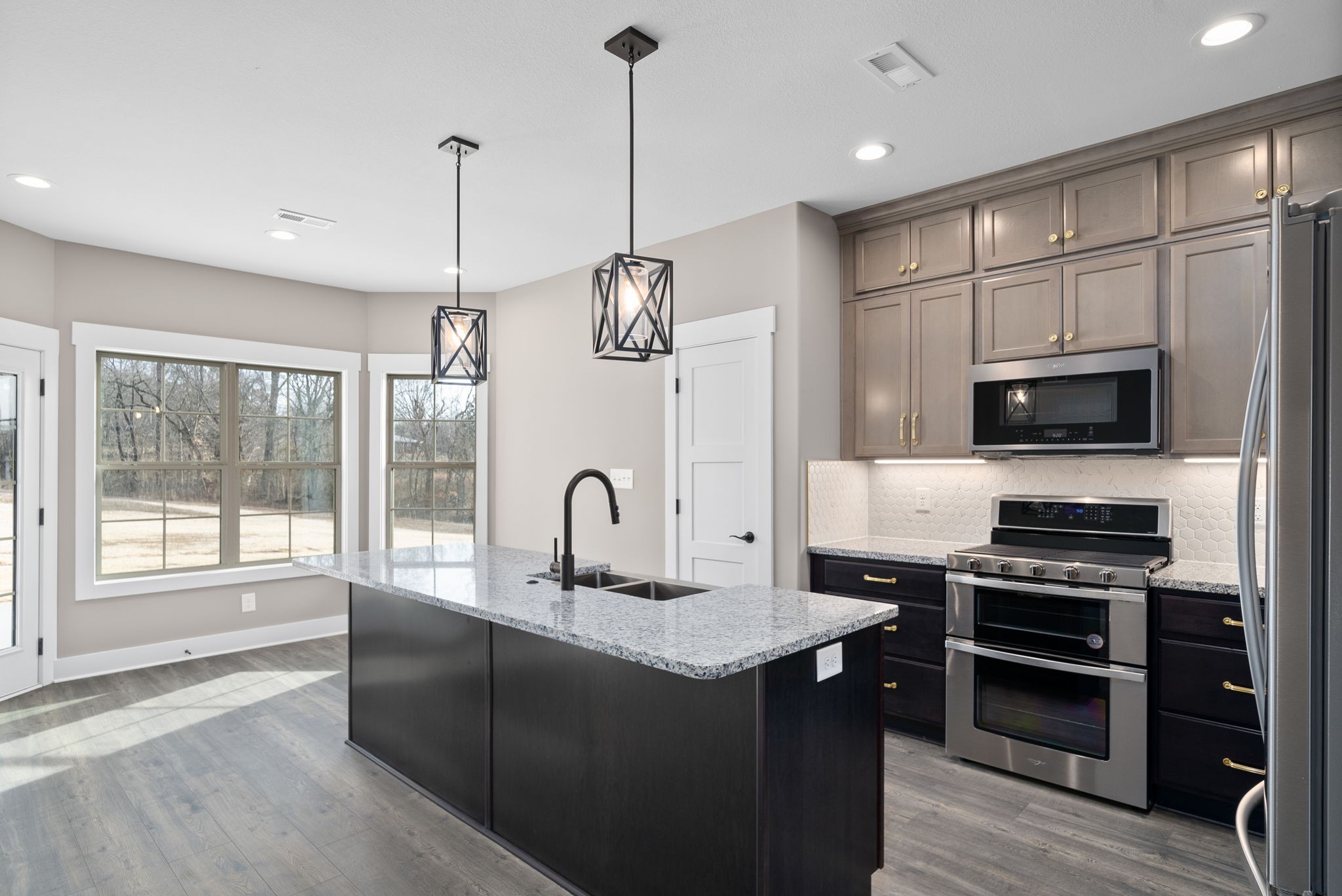 1059 Gratton Road Clarksville, TN 37043 - Photo 13 of 45 a kitchen with stainless steel appliances granite countertop a stove top oven a sink a oven with a dining table and chairs