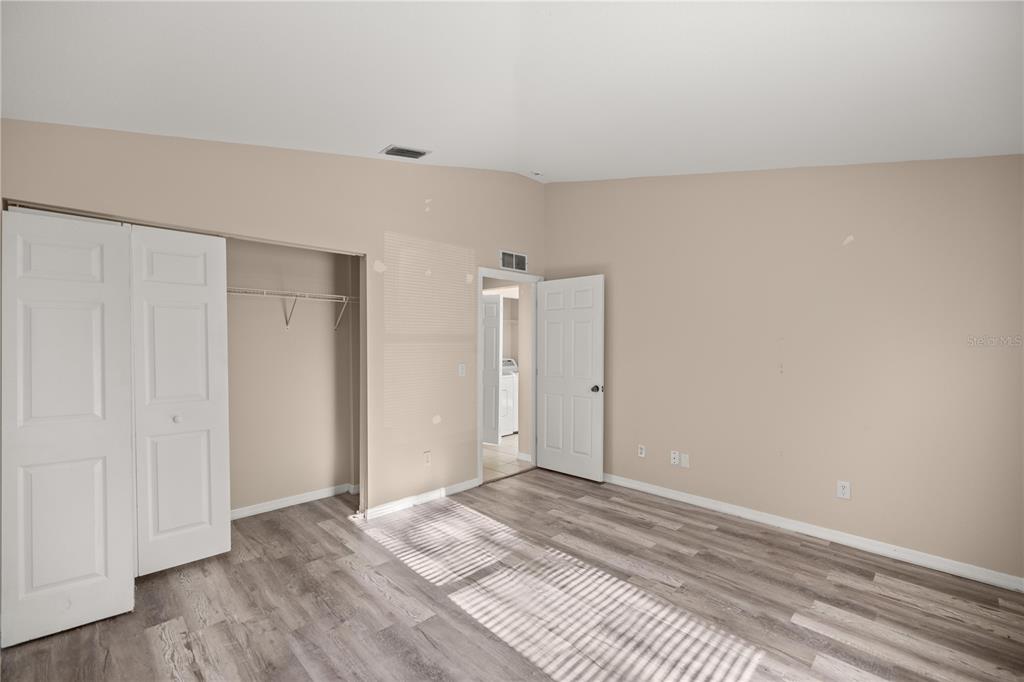 9680 Southwest 30th Terrace Ocala, FL 34476 - Photo 13 of 27 a view of a room with wooden floor and closet