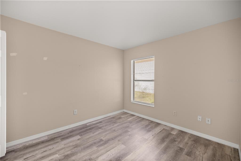 9680 Southwest 30th Terrace Ocala, FL 34476 - Photo 14 of 27 an empty room with wooden floor and windows