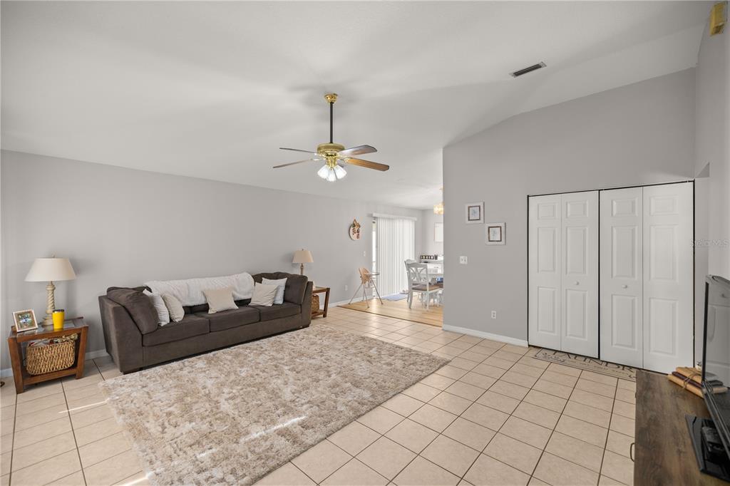 9680 Southwest 30th Terrace Ocala, FL 34476 - Photo 15 of 27 a living room with furniture and a chandelier