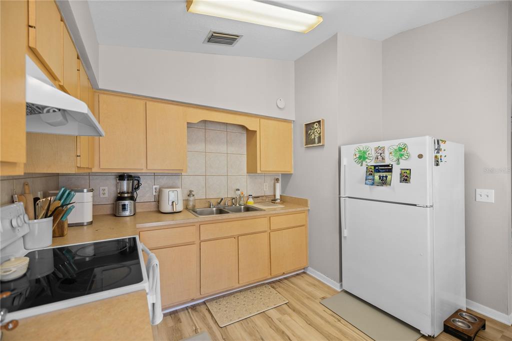 9680 Southwest 30th Terrace Ocala, FL 34476 - Photo 18 of 27 a kitchen with a sink a stove and cabinets