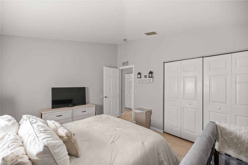 9680 Southwest 30th Terrace Ocala, FL 34476 - Photo 23 of 27 a bedroom with a bed and a flat screen tv