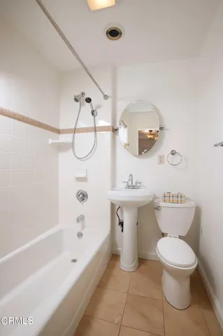 a bathroom with a toilet sink and shower