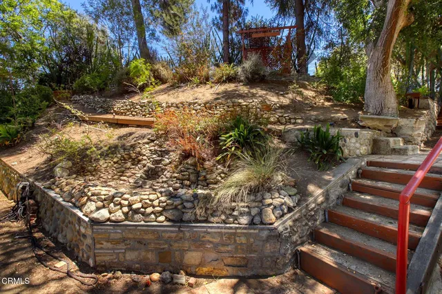 a view of backyard with barbeque grill and outdoor seating