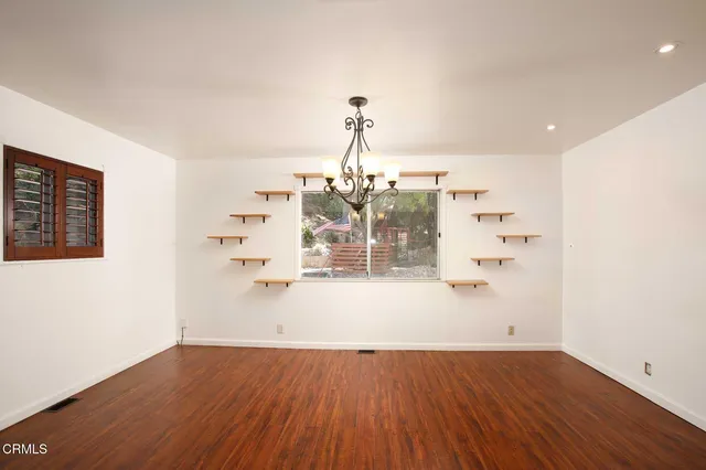 a view of a room with wooden floor