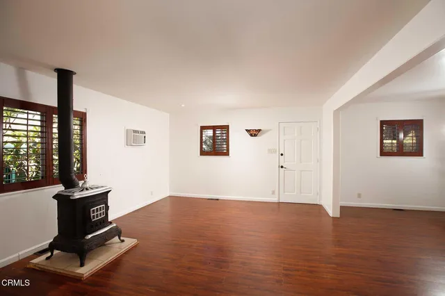 a view of workspace with wooden floor and windows