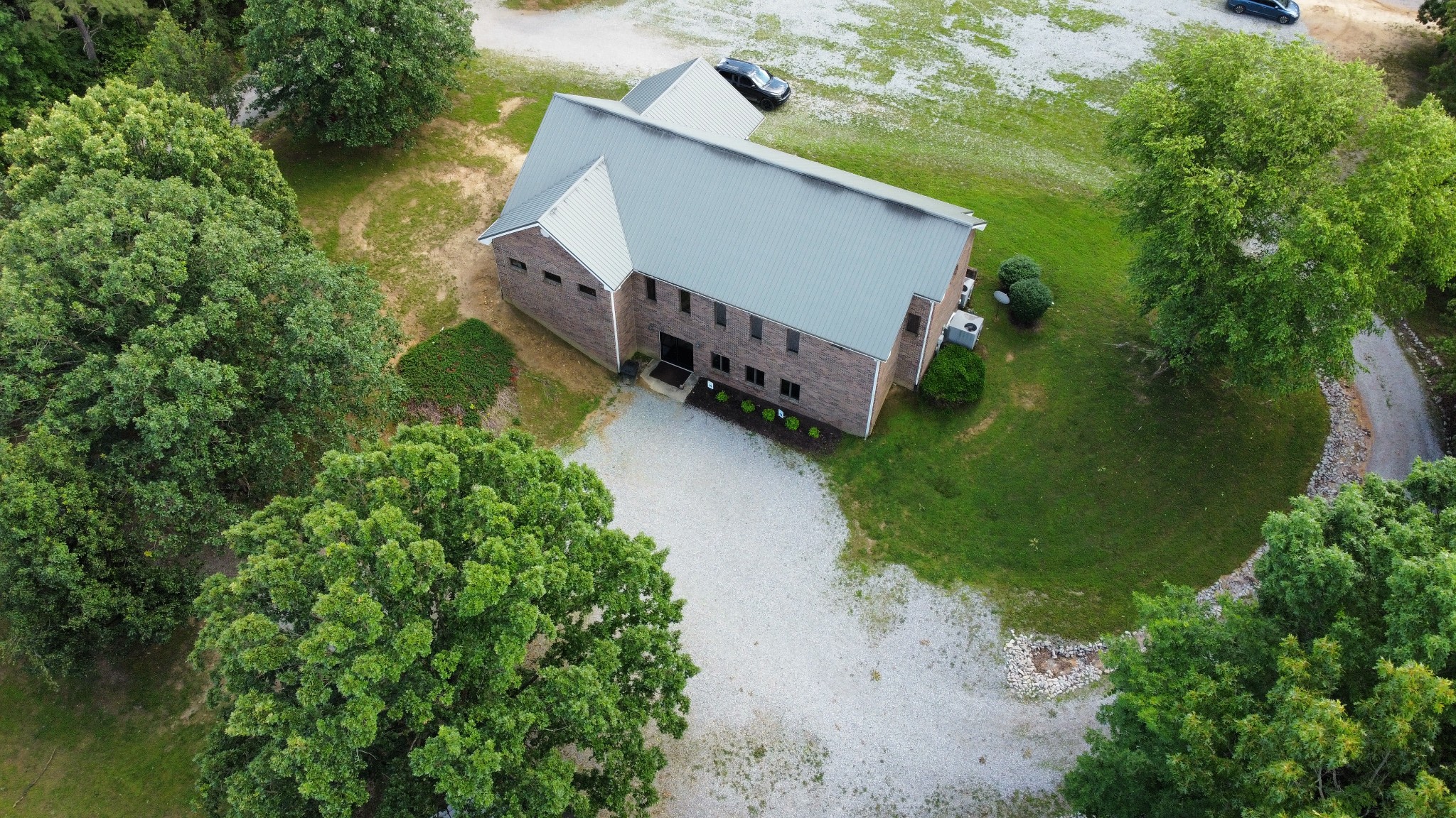 110 Hankins Road Hohenwald, TN 38462 - Photo 4 of 27 an aerial view of a house with roof deck and tree