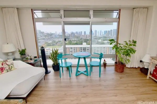 a living room with furniture and potted plants
