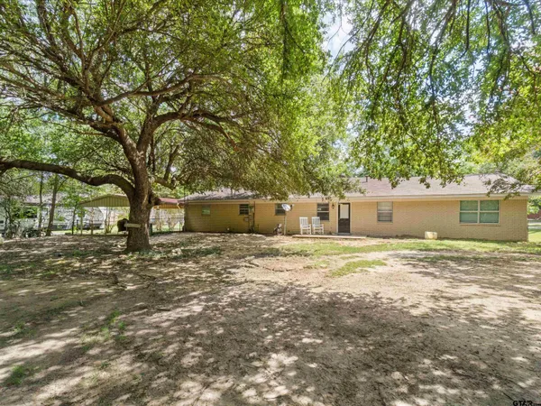 a big yard with large trees