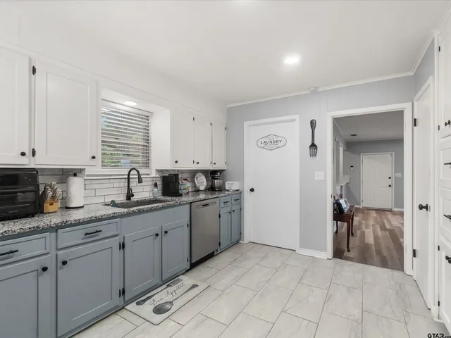 a kitchen with a sink and cabinets