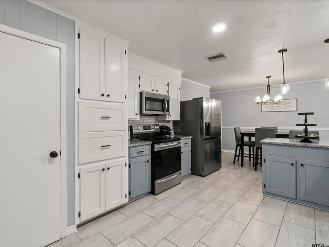 a kitchen with cabinets and stainless steel appliances