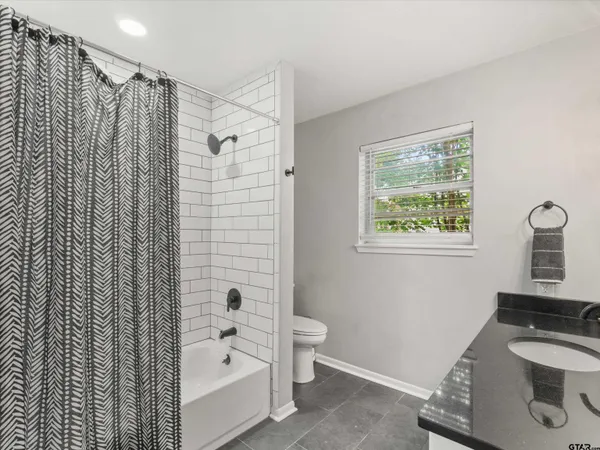 a bathroom with a shower curtain and a sink