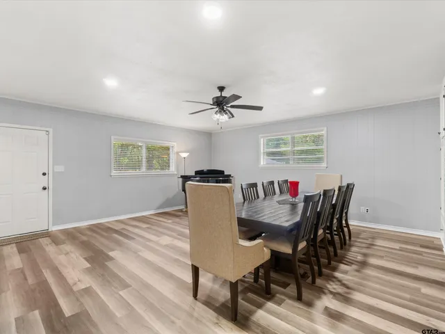 a dining room with furniture a window and wooden floor