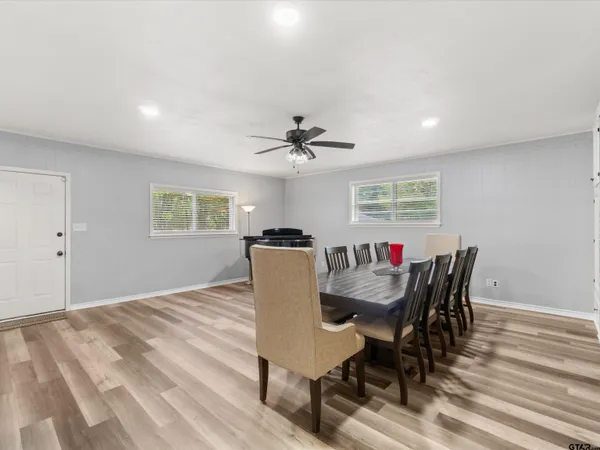 a dining room with furniture a window and wooden floor