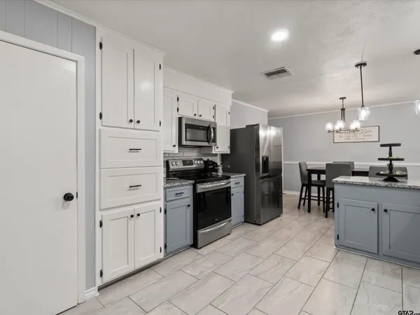 a kitchen with cabinets and stainless steel appliances