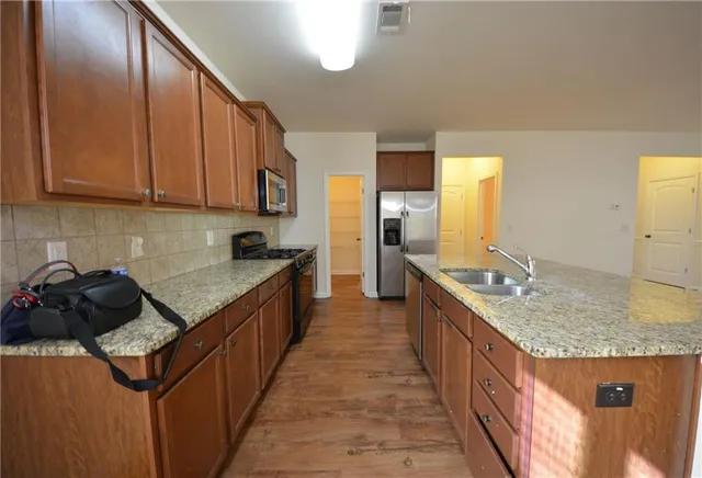 a kitchen with a stove and a refrigerator