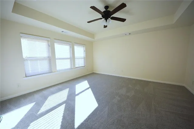 a spacious bathroom with double vanity and a mirror