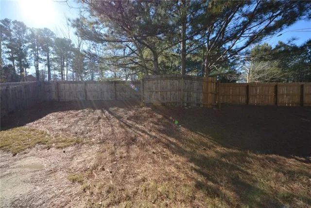 a view of a hallway with wooden floor and stairs