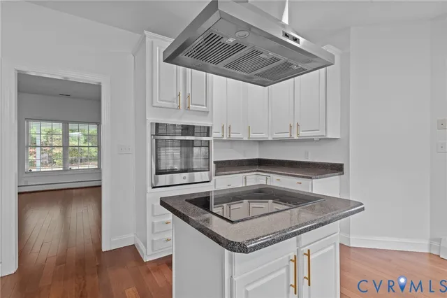 a kitchen that has a sink and a stove in it