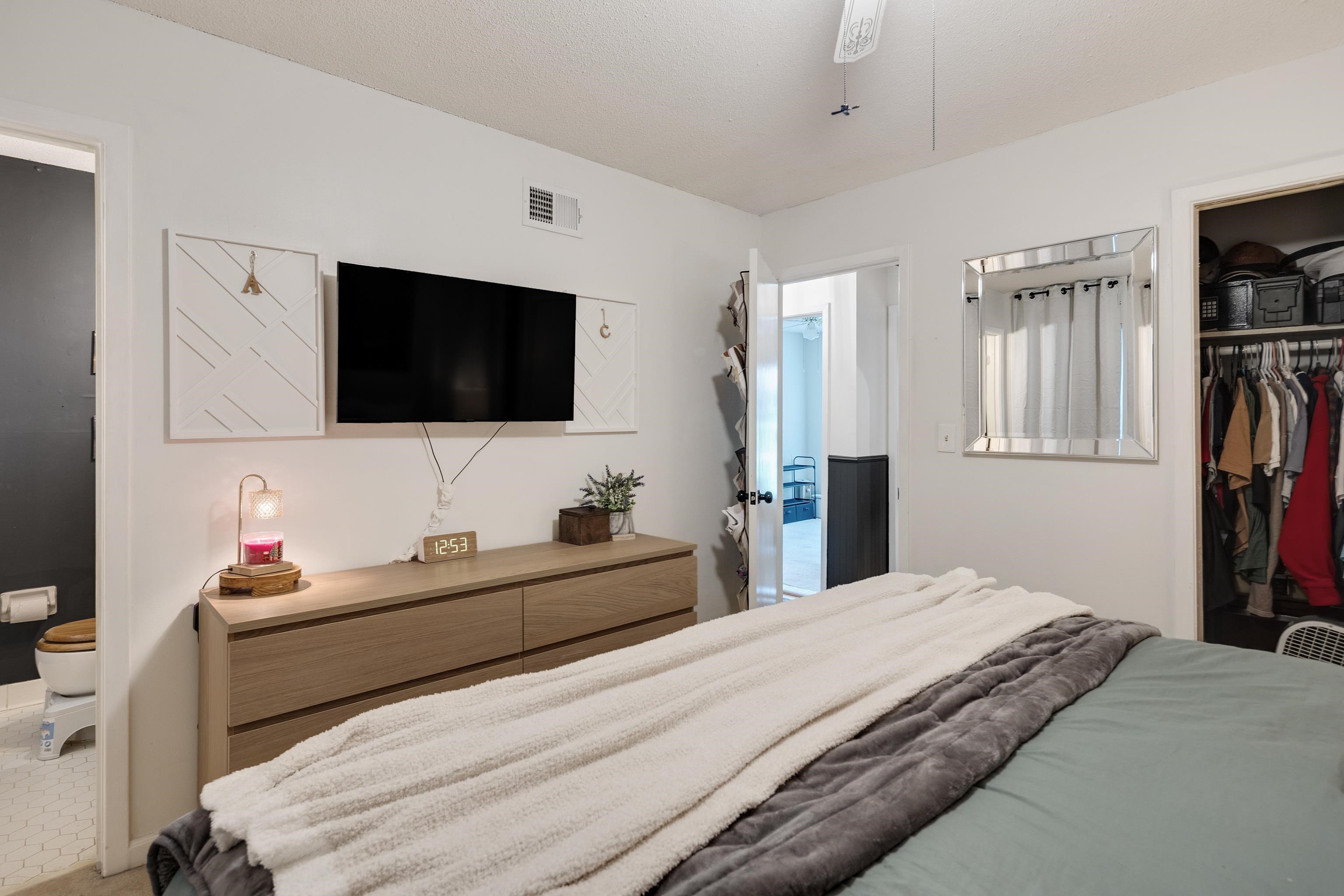 1137 Greenview Road Collierville, TN 38017 - Photo 24 of 35 a bedroom with a bed and a flat screen tv