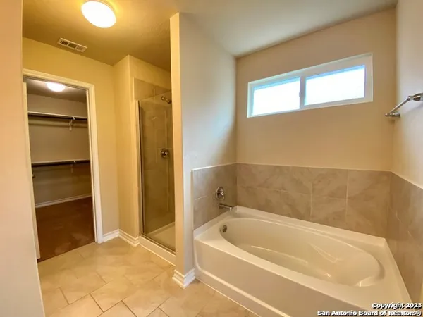 a bathroom with a bathtub and a shower