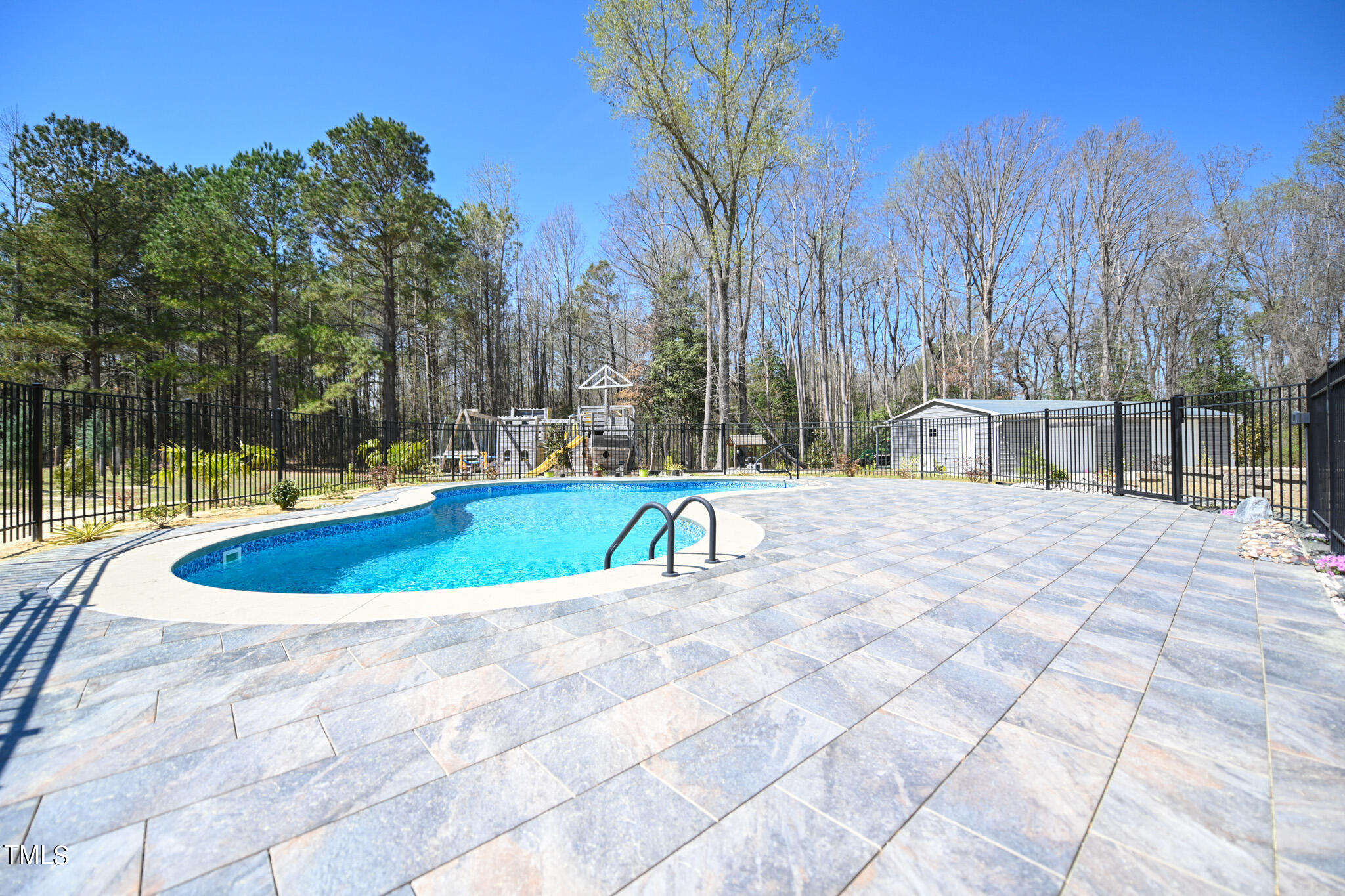 664 Old Fairground Road Willow Spring, NC 27592 - Photo 12 of 40 a swimming pool with outdoor seating and yard