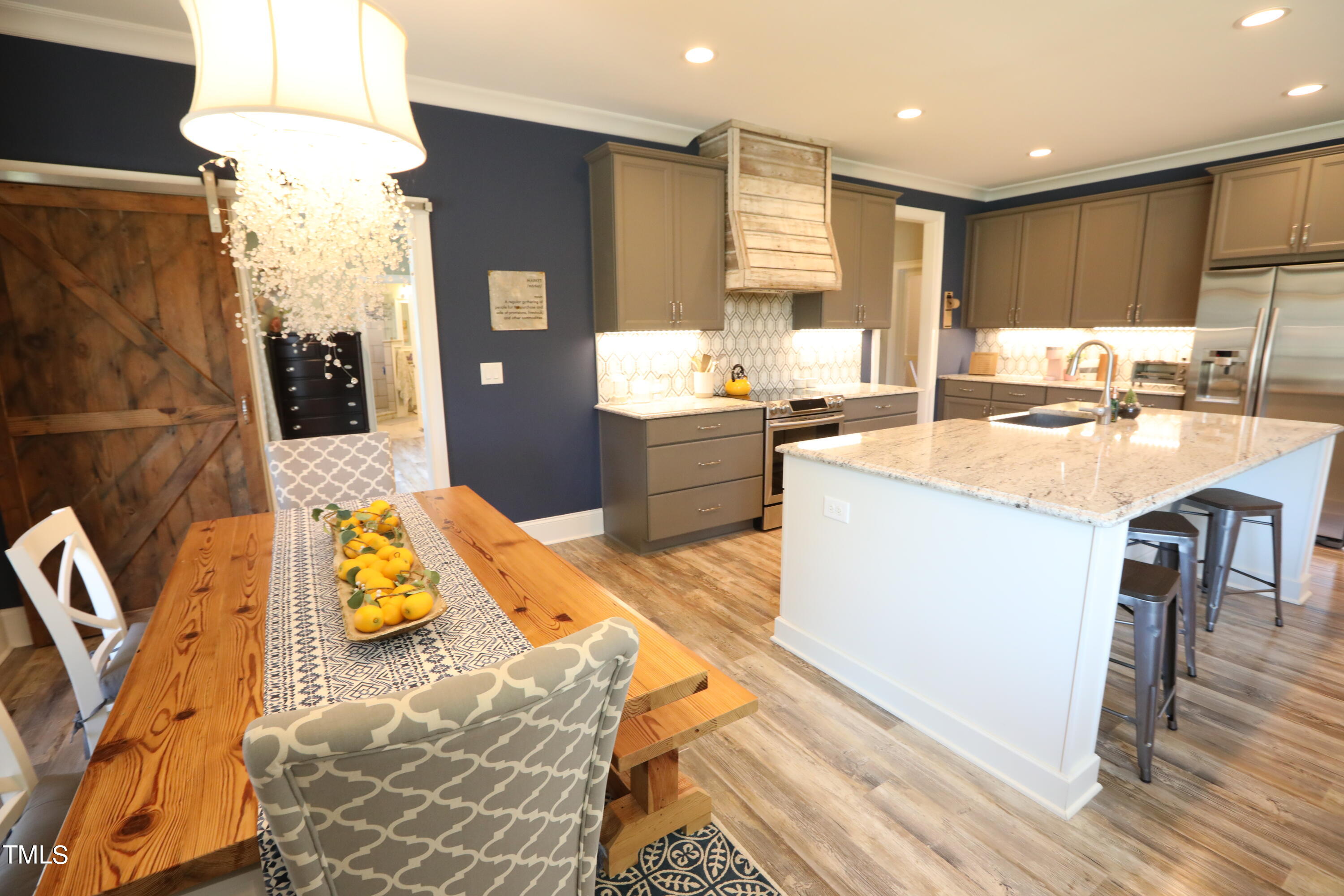664 Old Fairground Road Willow Spring, NC 27592 - Photo 19 of 40 a large kitchen with stainless steel appliances kitchen island granite countertop a sink and cabinets