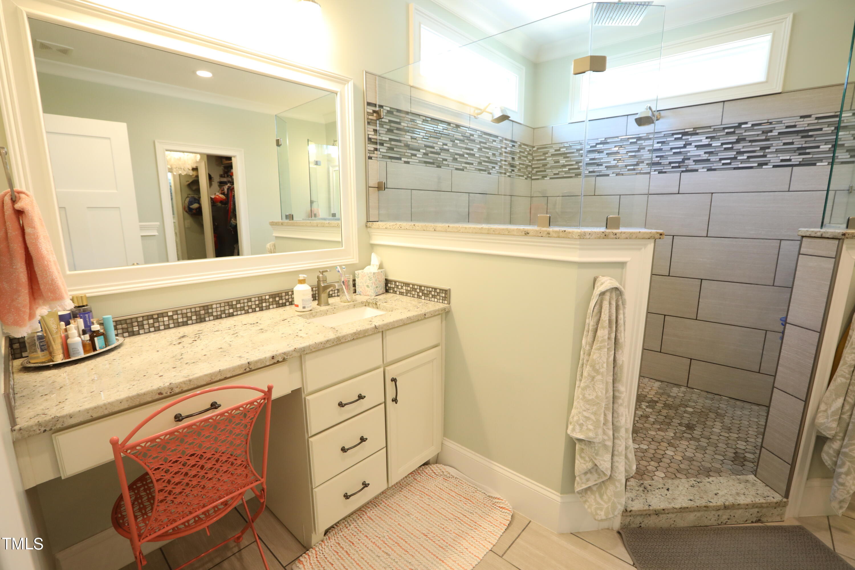 664 Old Fairground Road Willow Spring, NC 27592 - Photo 24 of 40 a bathroom with a granite countertop sink a mirror and shower