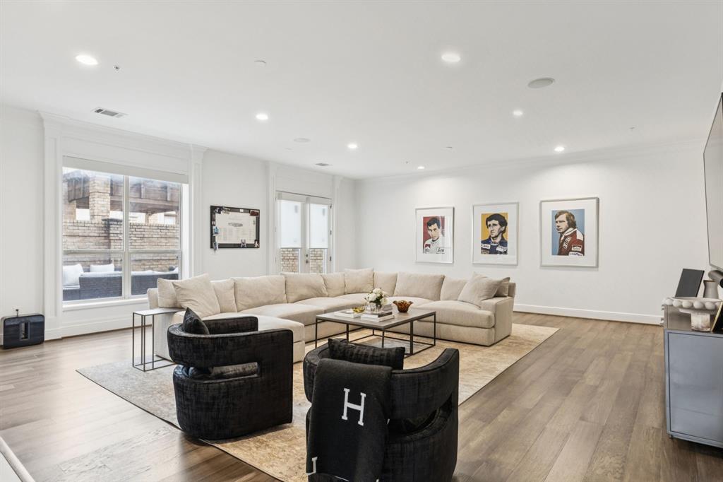 a living room with furniture window and wooden floor