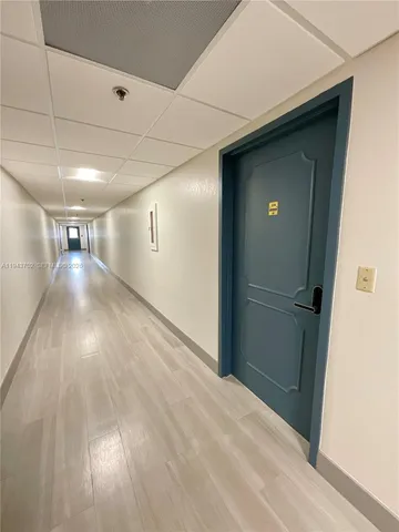 a view of hallway with wooden floor