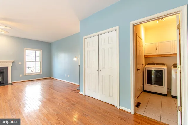 a view of empty room with window and wooden floor