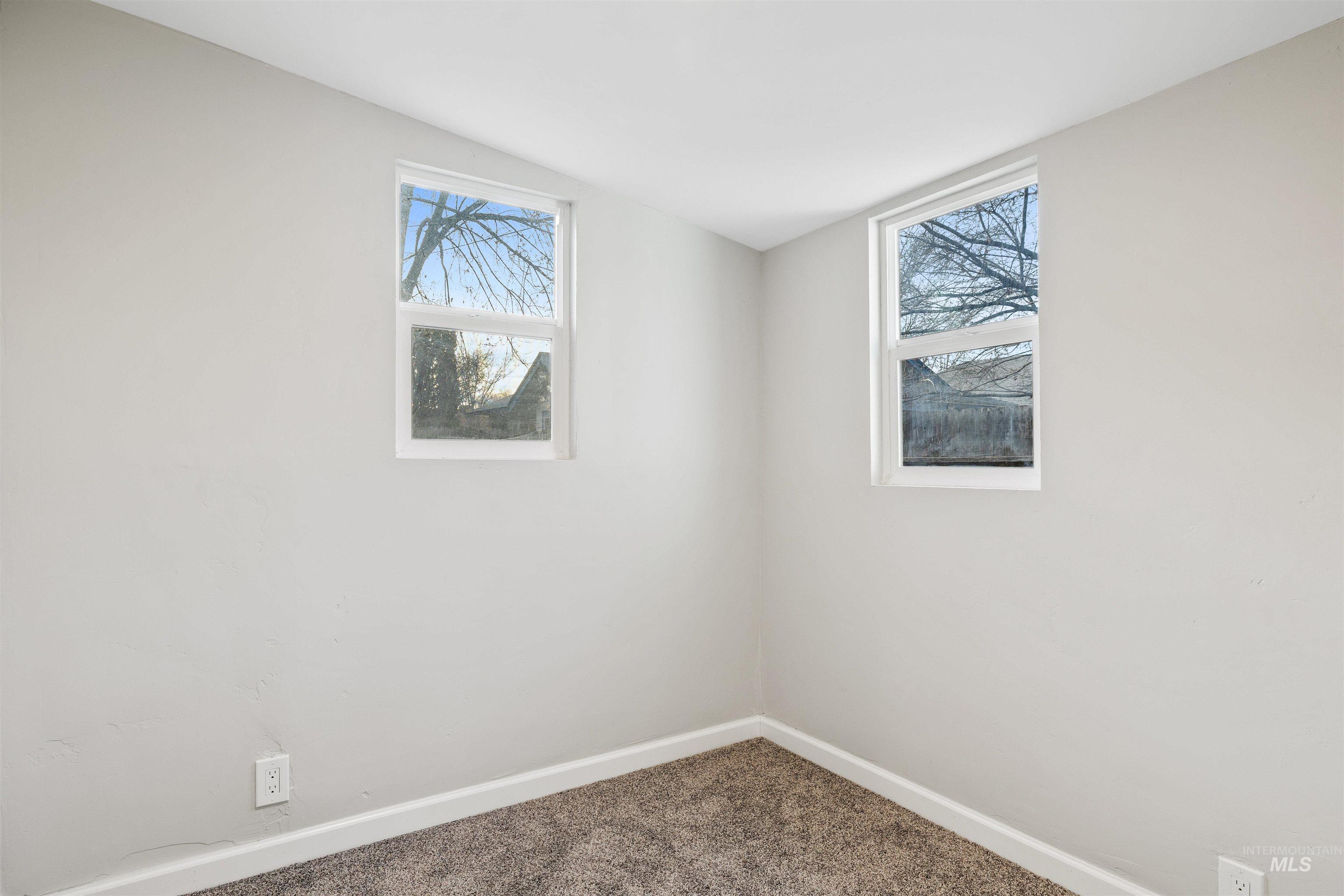 617 Eden Street North Twin Falls, ID 83301 - Photo 13 of 25 Carpeted empty room featuring baseboards