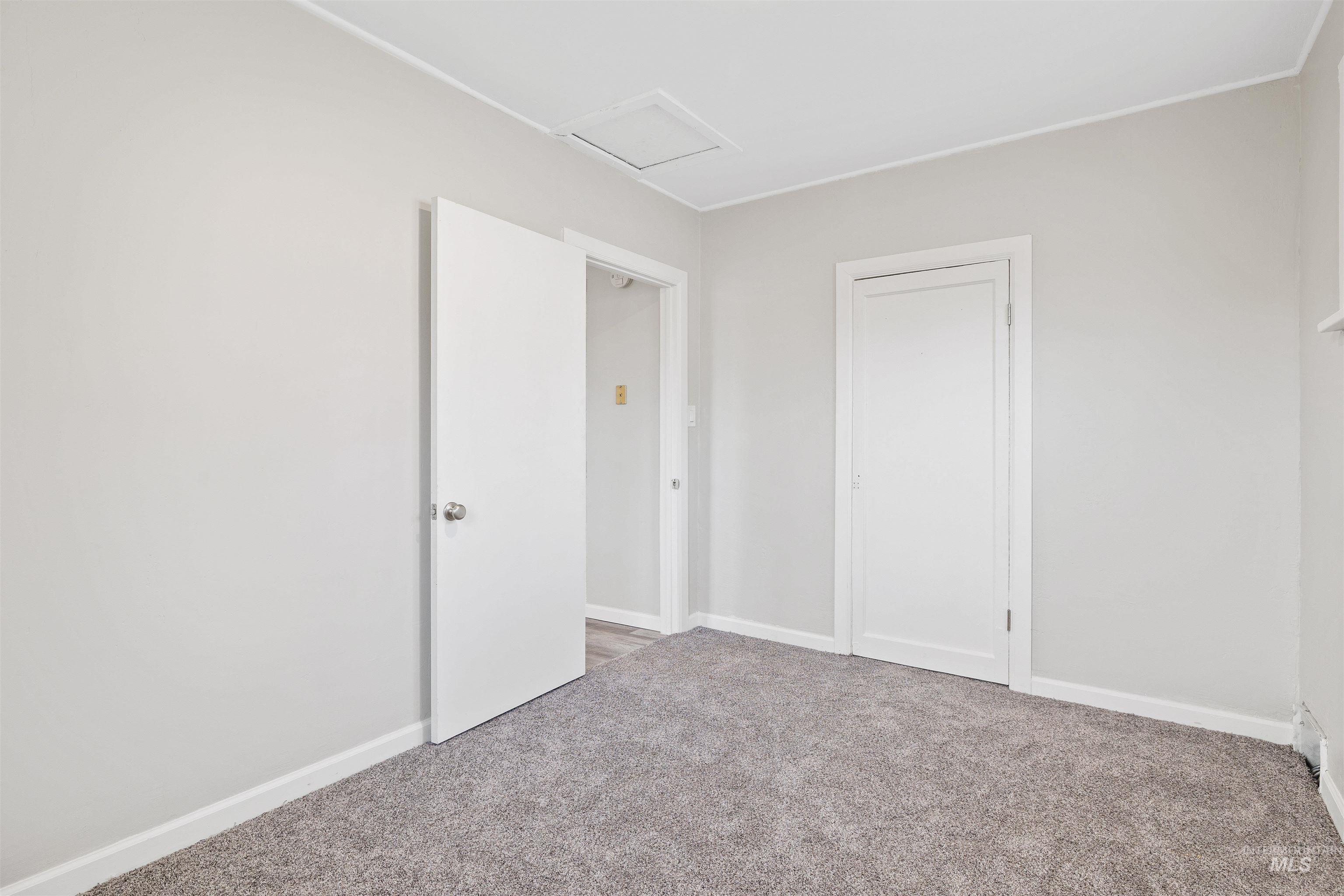 617 Eden Street North Twin Falls, ID 83301 - Photo 16 of 25 Unfurnished bedroom featuring attic access and light carpet