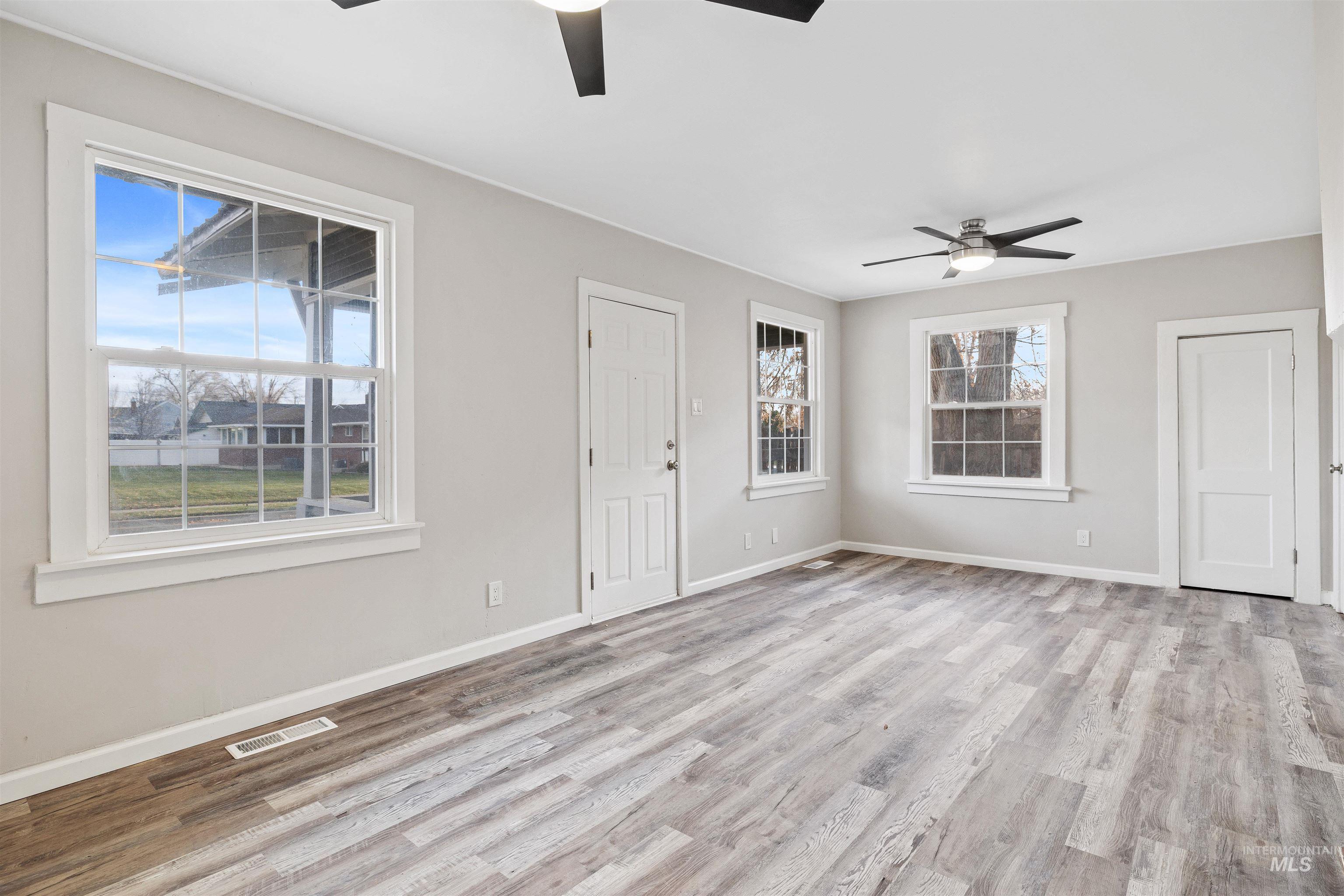 617 Eden Street North Twin Falls, ID 83301 - Photo 5 of 25 Unfurnished living room featuring ceiling fan and light wood finished floors